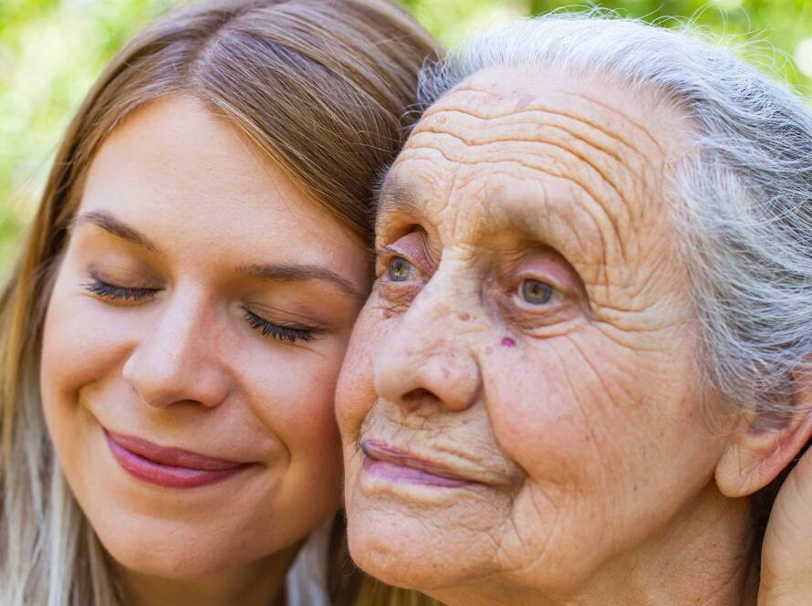 Young woman hugging older woman in supportive environment